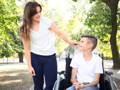 Mamma con figlio sulla sedia a rotelle