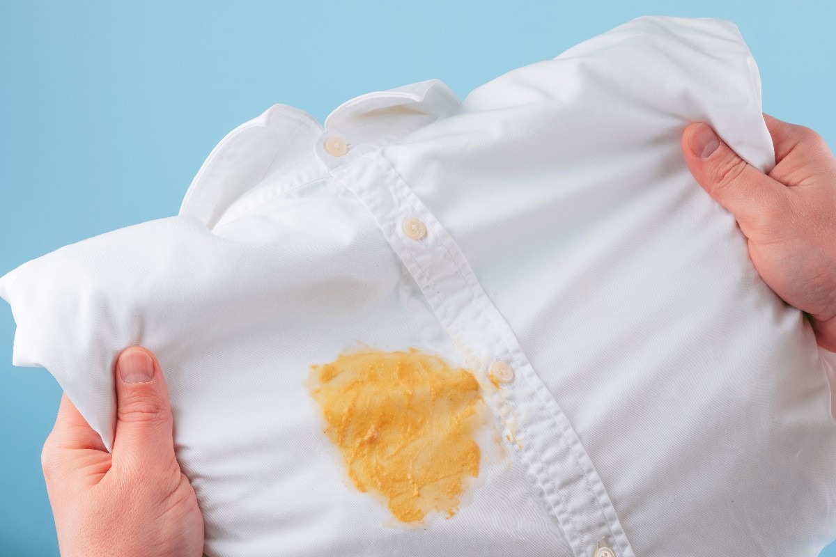 Una macchia gialla sulla camicia bianca