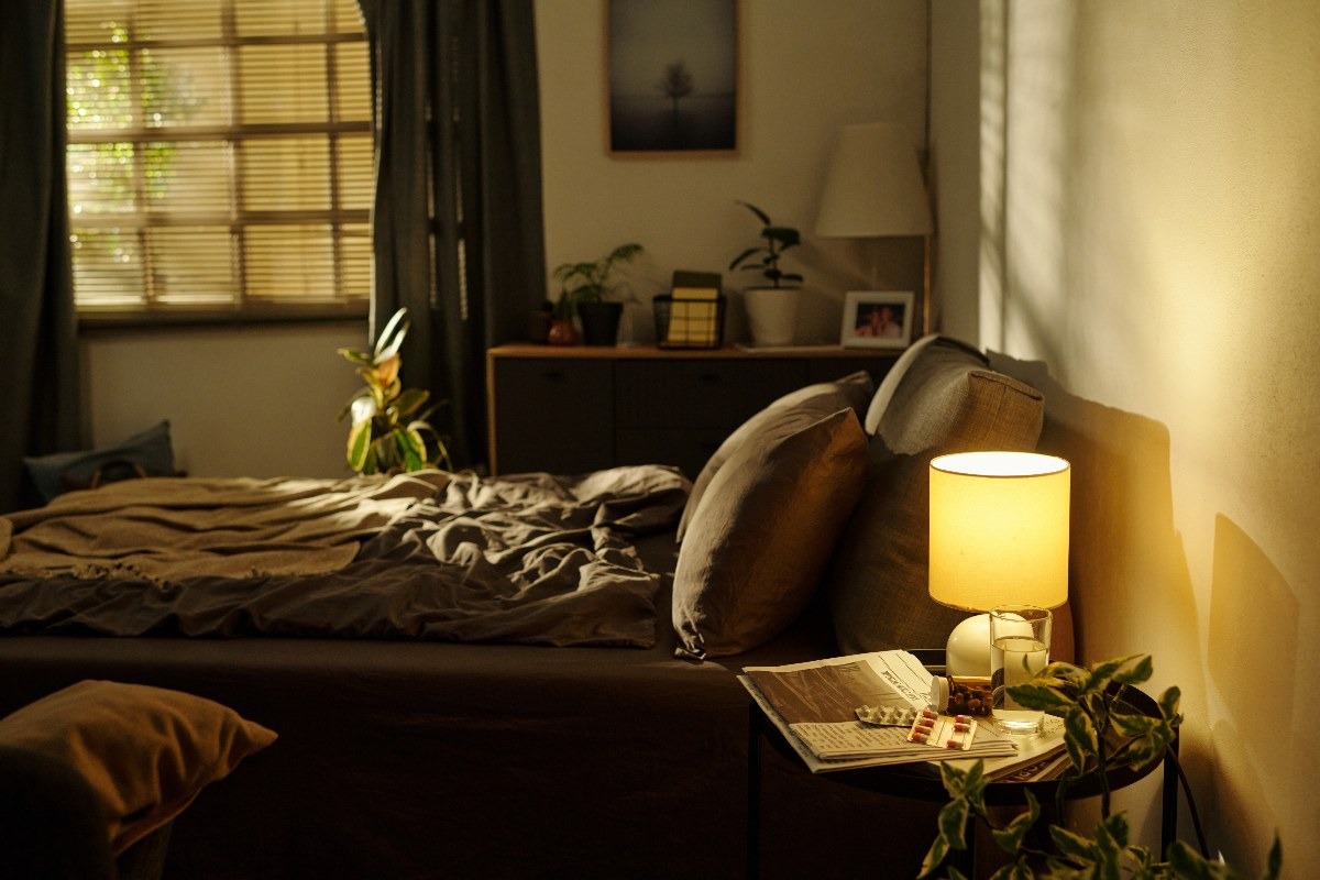 Una camera da letto con il letto in disordine e l'abat jour accessa